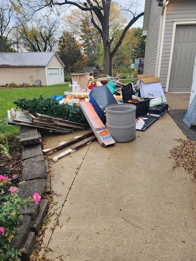 Dumpster being loaded with debris for Estate Cleanout Dumpster Rental in Wakefield